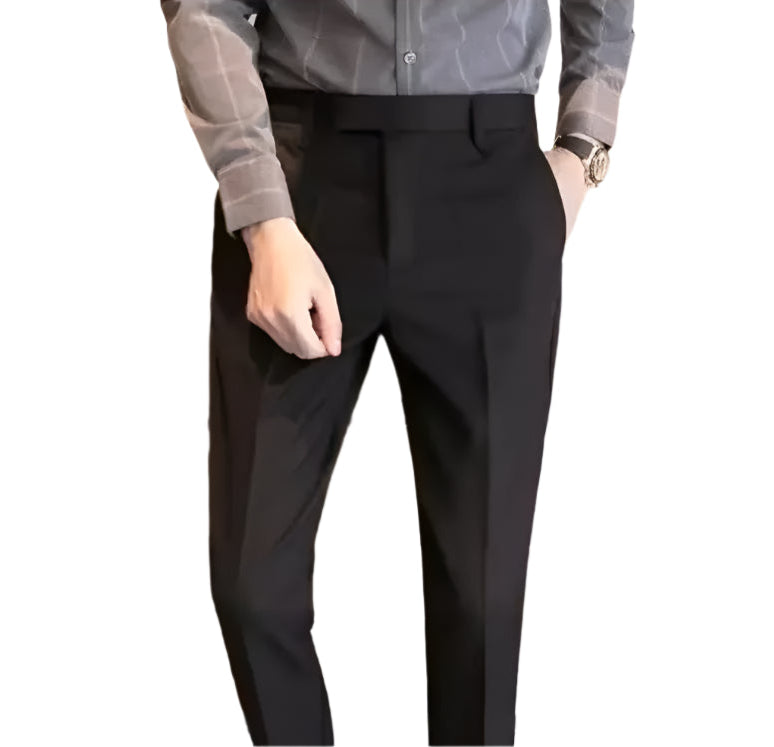 Person wearing black dress pants with a blurred background