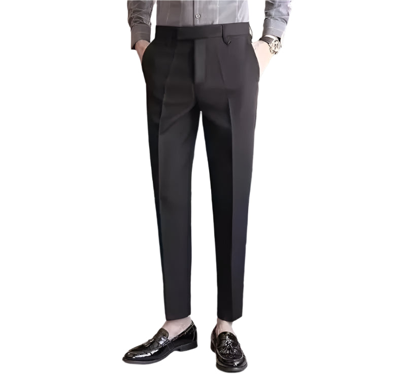Dark gray pants worn by a person on a white background